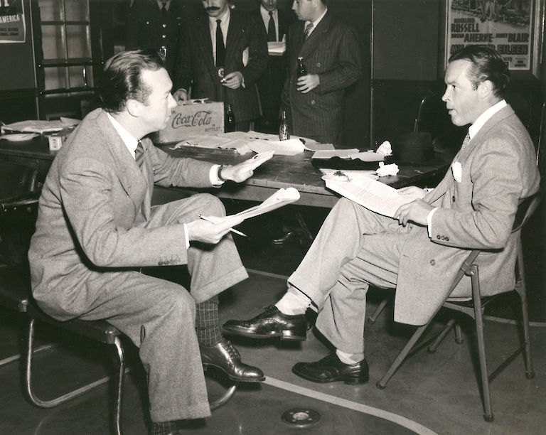 This 1942 image of Bob Hope (right) and others provides a view of the Presidio Theater lobby facing southwest. The front doors (above left) and flooring correspond to details from the original plans for the theater. Photo: U.S. Army / Presidio Trust Library